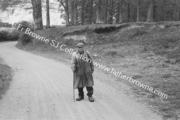 TRAMP WALKING ALONG ROAD